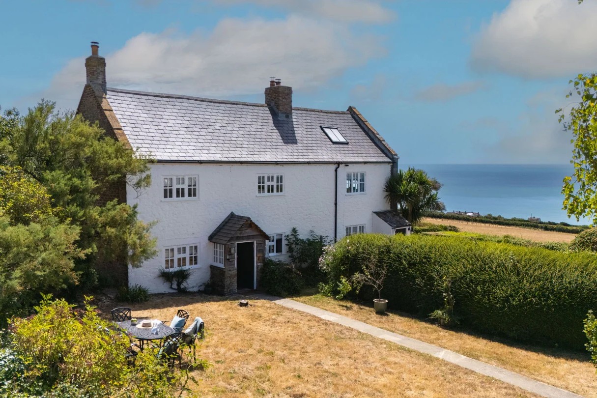 White farm cottage with sea views at Labour in Vain Cottage, Dorchester, Dorset